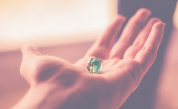 Balance, hand holding a marble