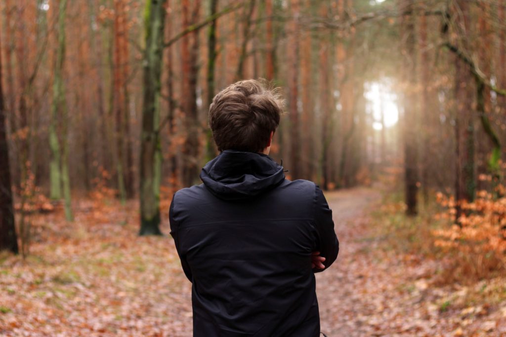 man standing in forest