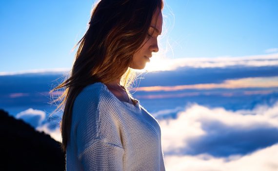 woman standing with clouds in the background